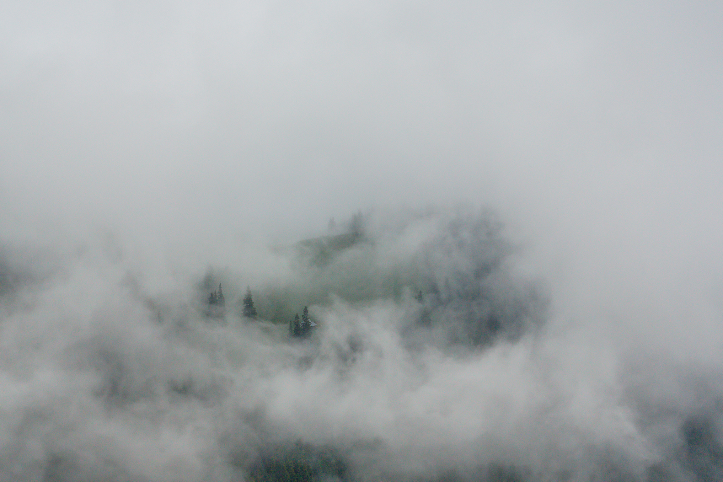 Mountain scenery in the Transylvanian Alps in spring, with rain clouds and fog
